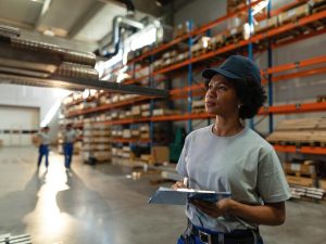 african-american-female-worker-taking-notes-while-inspecting-steel-products-warehouse