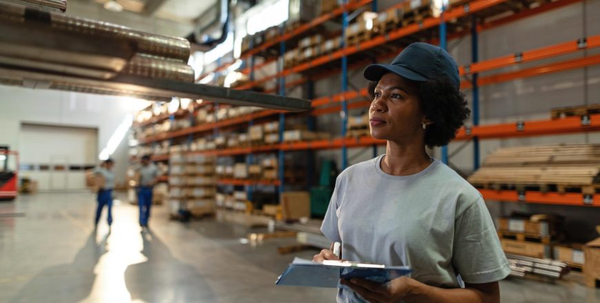 african-american-female-worker-taking-notes-while-inspecting-steel-products-warehouse